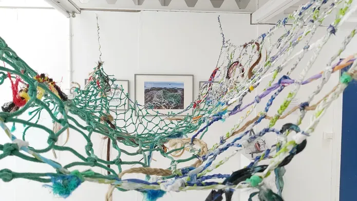 green and blue fishing net strung up on ceiling 