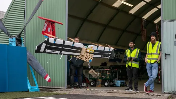 2 people on an airport hanger with the aerospace device 