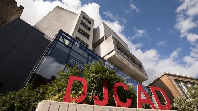 exterior of building with large red letters DJCAD