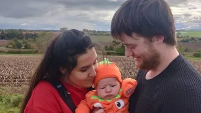 Eshar and Georgie holding Baby Archie