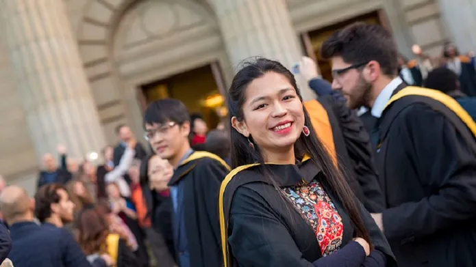 Xiaoxiao-Zhang standing outside Caird Hall after graduation