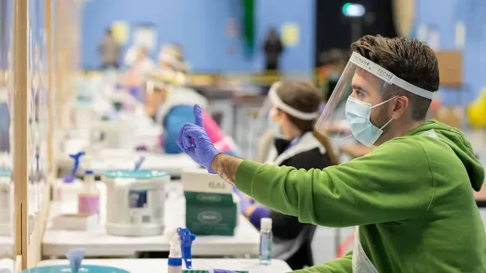 a lab with a person in a face mask working 