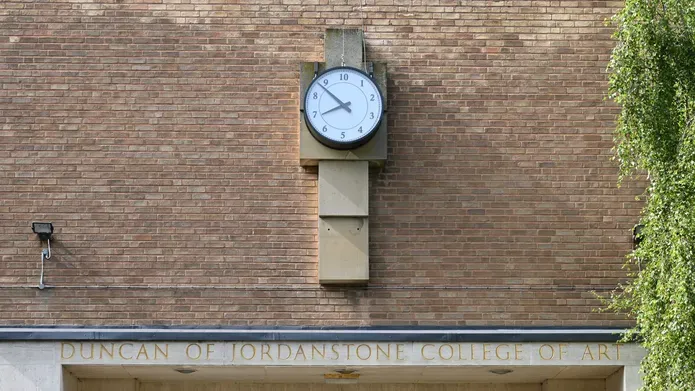 mid shot of clock installation on red brick of Dundee's cooper gallery