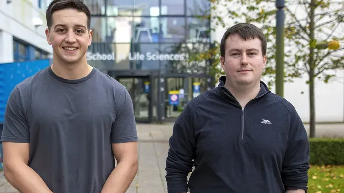 Scientists standing outside the Discovery Centre building