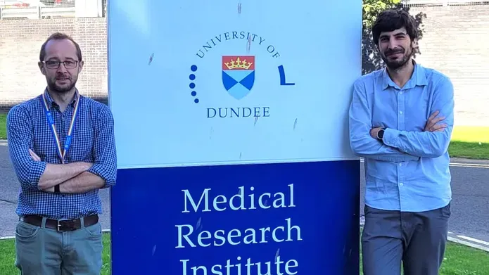 2 men infront of Medical reseach institute sign