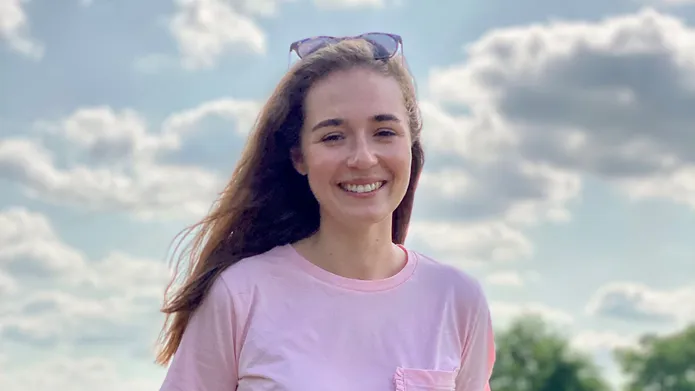 Jasmin Hirn with the sky and clouds behind her