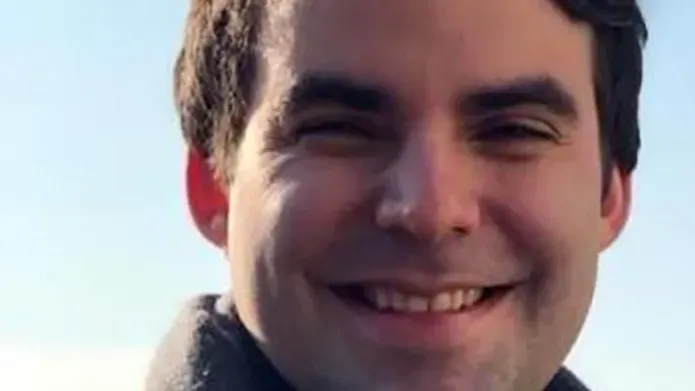 portrait of Kirby Swatek against blue sky