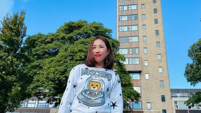 Jing Yang standing at the front of the Tower Building