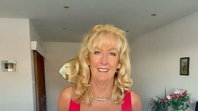 Fundraiser Fiona Edwards holds cheque for £4500 for breast cancer research