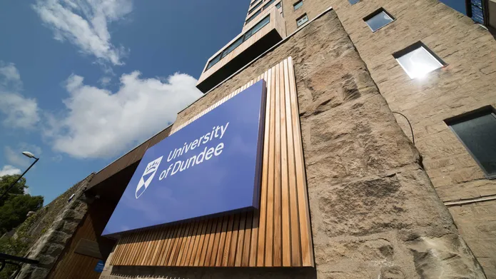 Tower Building with the University of Dundee logo and blue skies above