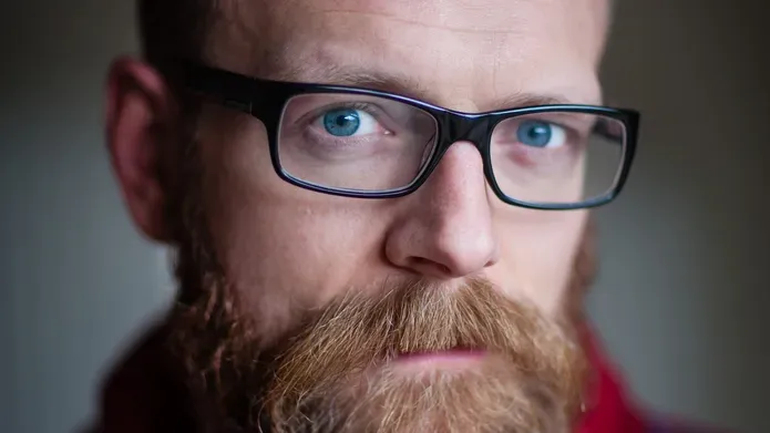 Middle aged man with beard and glasses