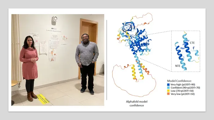 Man and woman standing by poster showing DNA