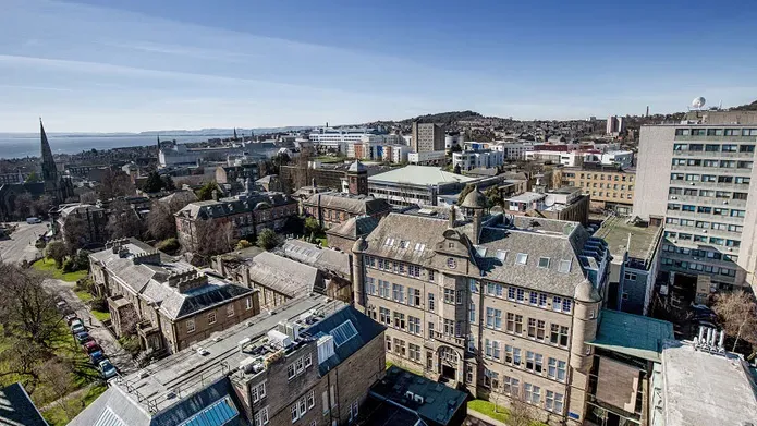 Aerial view of the city campus with blue skies and view of the Old Medical School and Geddes Quadrangle