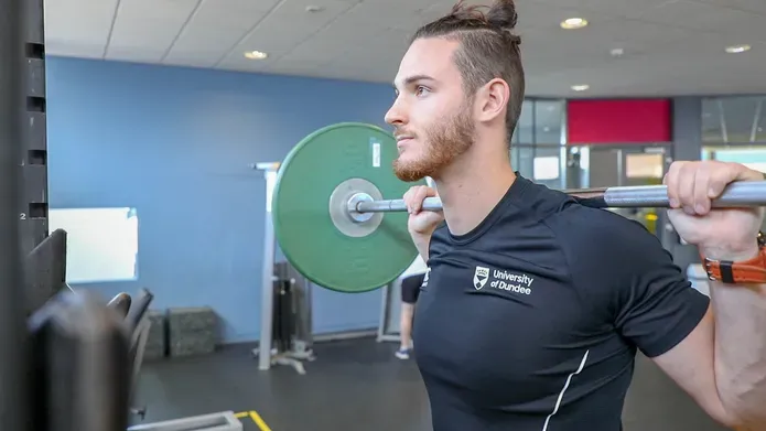 A gymgoer lifting weights at the Strength Performance Centre