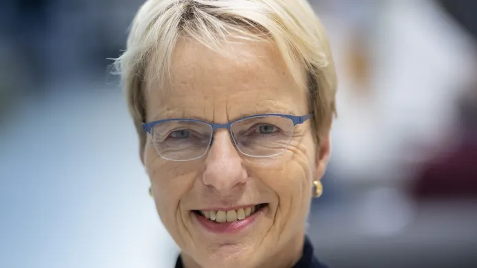 Picture of woman with glasses smiling at camera