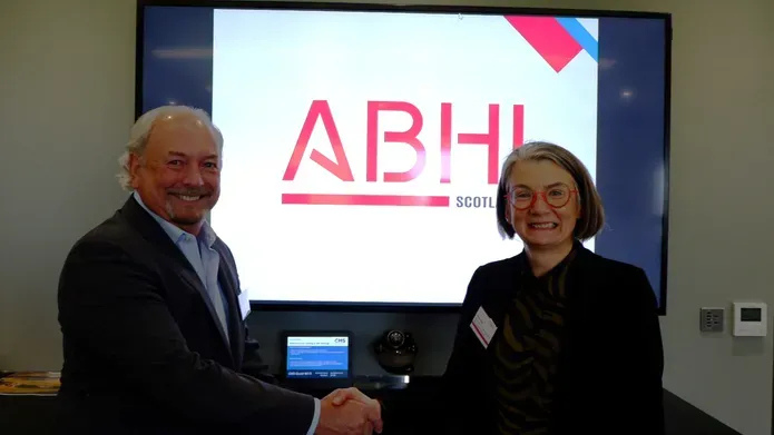 Man and woman shaking hands to signify signing of MoU