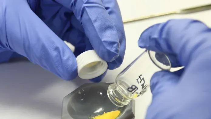 Scientist removes drugs from storage capsule