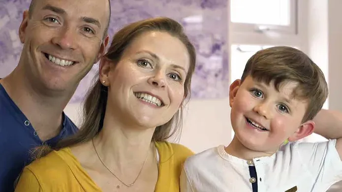 A family photo of Sabine with her partner, and son Calvin