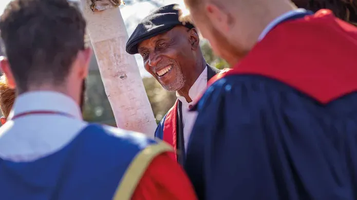 Keith Harris standing talking to others