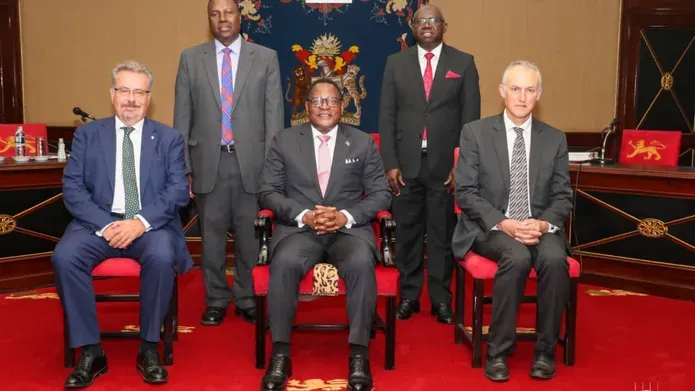 Professors Iain Gillespie and Paul van Gardingen, sit with His Excellency, Dr Lazarus McCarthy Chakwera, President of Malawi
