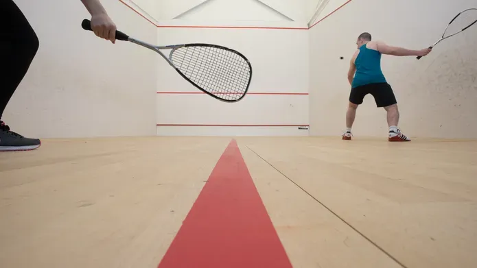 Two people play squash on the courts at Institute of Sport and Exercise