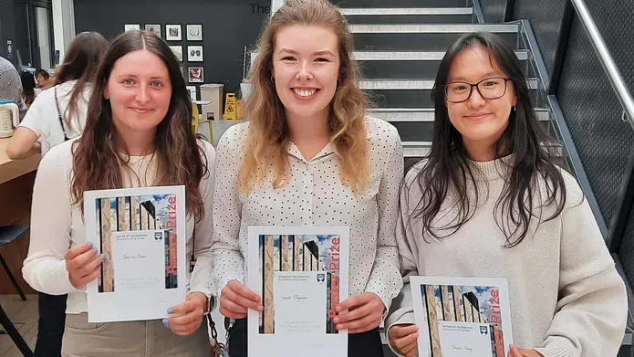 Three School of Life Sciences Summer School Poster winners holding their awards