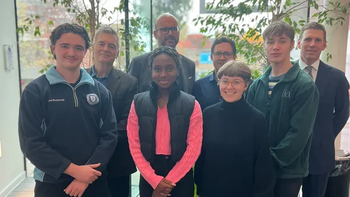 A group of law alumni mentors stand behind potential student mentees