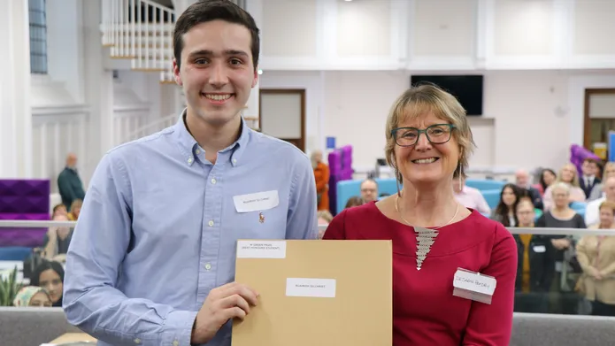 Dr Sarah Hendry handing out Dundee Law School award to a student