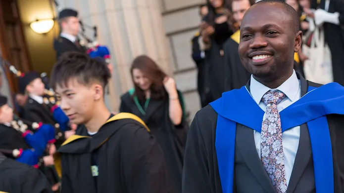 Student outside Caird Hall at Winter Graduation
