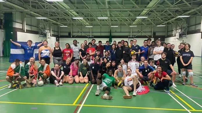 Picture of Volleyball club members together showing off national regalia