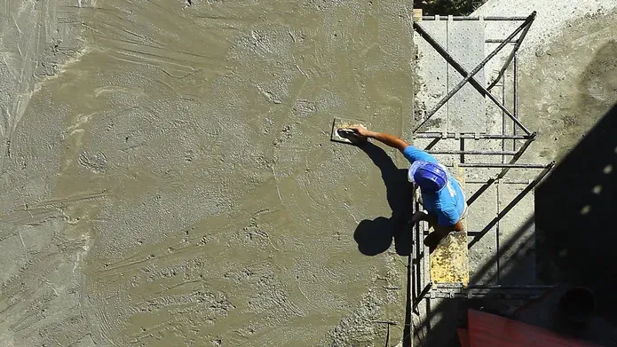 Man laying concrete rotated