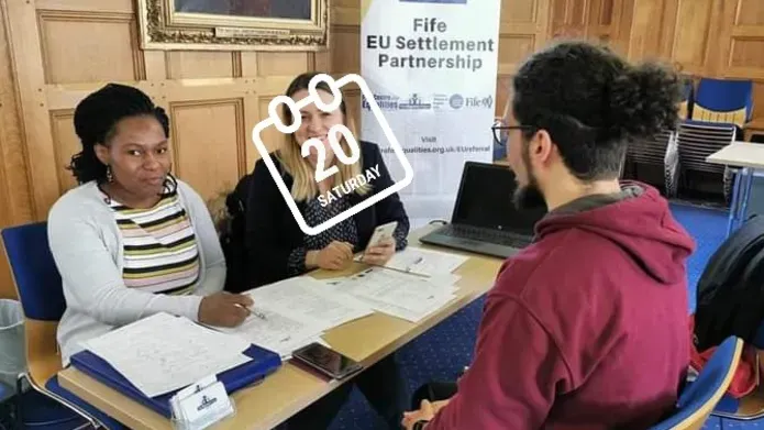 people completing paperwork at a table
