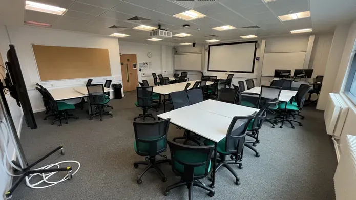 Dalhousie 1G06  - several white tables set in squares with black chairs spread out across the room