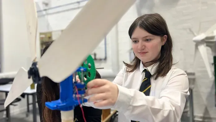 A pupil from Arbroath Academy building a mini wind turbine as part of an activity at the University of Dundee