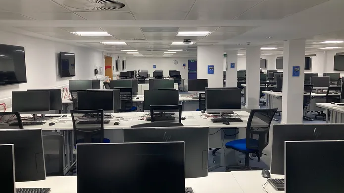 IT Suite in Tower Basement showing rows of desks with computer screens