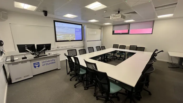 Dalhousie1G15 - white table set in a square with tv screen on the wall