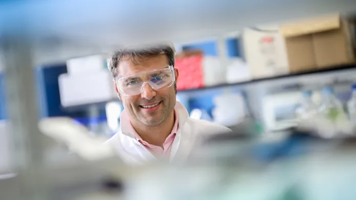 Alessio Ciulli wearing a lab coat in the laboratory 