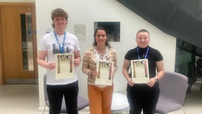 Poster prize winners holding their certificates 