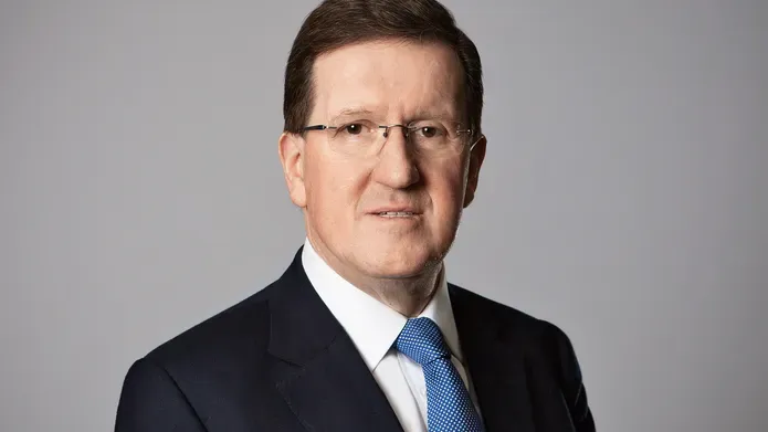 Lord Robertson in black suit and blue tie