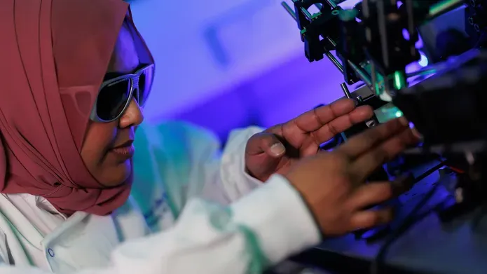 Researcher working in lab wearing protective glasses