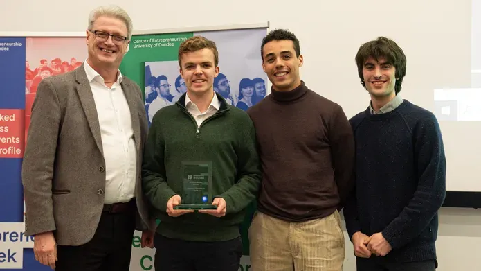 Professor Blair Grubb stands with the Cognicall team and their award