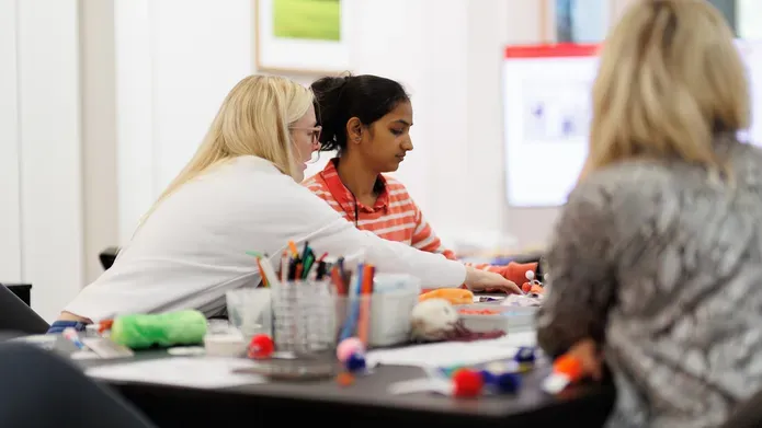 Teacher supporting student in classroom