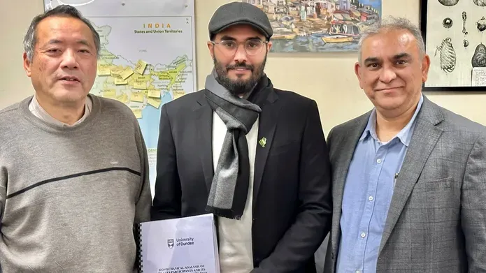 Ahmad Ghazwani and team standing with his PhD paper