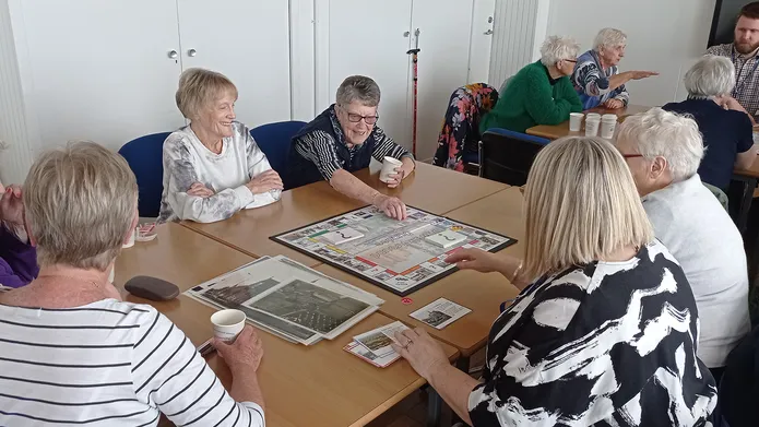 Young at Heart group sitting at a table playing a board game