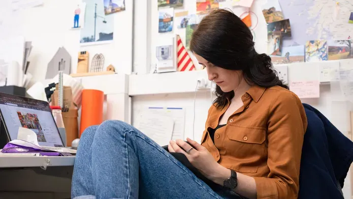 student sitting by laptop