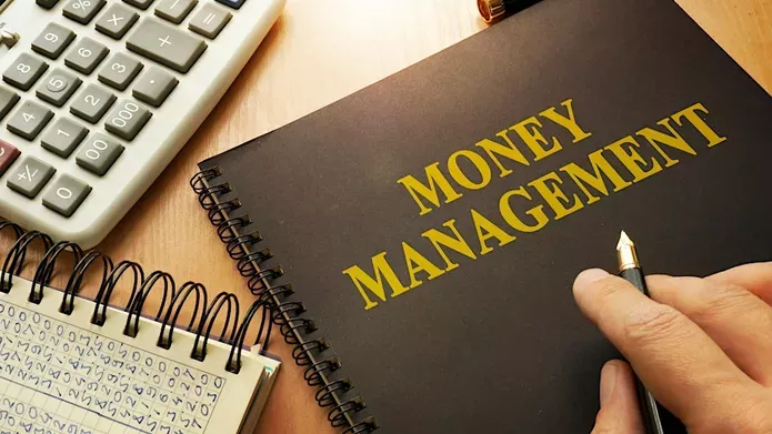 A notebook with Money Management on the front cover