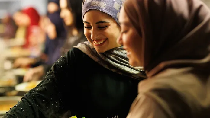 Image of two students enjoying the iftar meal