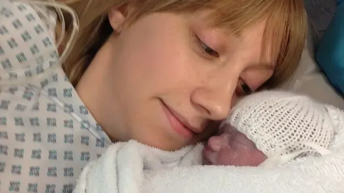 A young mum holding her new born daughter