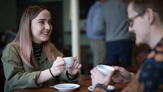 two students sharing coffee