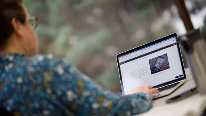 side profile of woman working on laptop